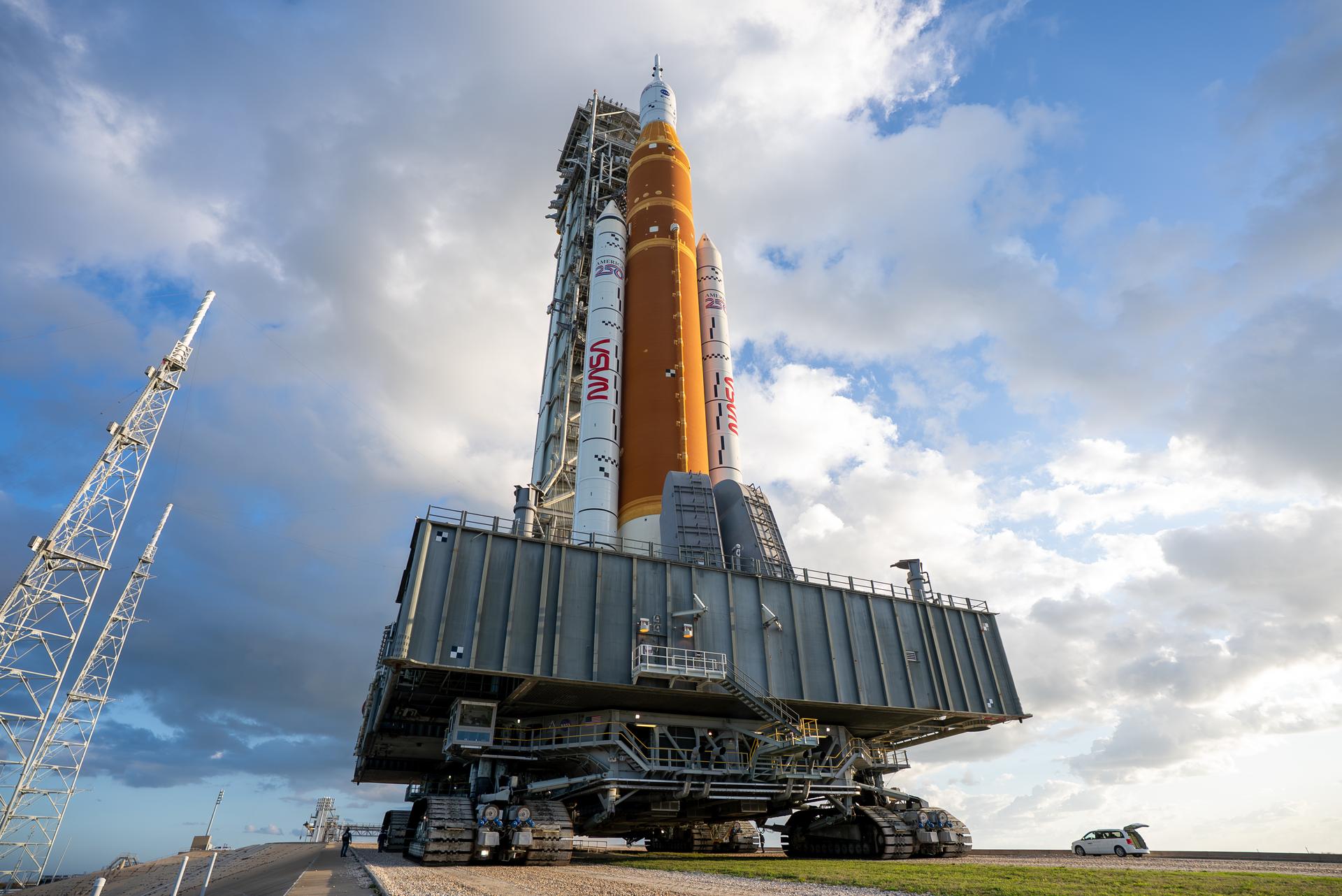 This image shows NASA’s SLS (Space Launch System) and Orion spacecraft rolling out of the Vehicle Assembly Building at NASA’s Kennedy Space Center. NASA's massive Crawler-Transporter, upgraded for the Artemis program, carries the powerful SLS rocket and Orion spacecraft on the Mobile Launcher from the Vehicle Assembly Building to Launch Pad 39B at Kennedy Space Center in preparation for the Artemis II mission. 